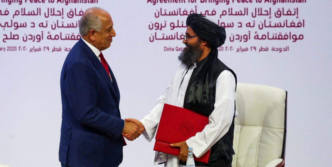 Mullah Abdul Ghani Baradar, the leader of the Taliban delegation, and Zalmay Khalilzad, U.S. envoy for peace in Afghanistan, shake hands after signing an agreement at a ceremony between members of Afghanistan's Taliban and the U.S. in Doha, Qatar February 29, 2020. REUTERS/Ibraheem al Omari - RC2LAF91DVTE